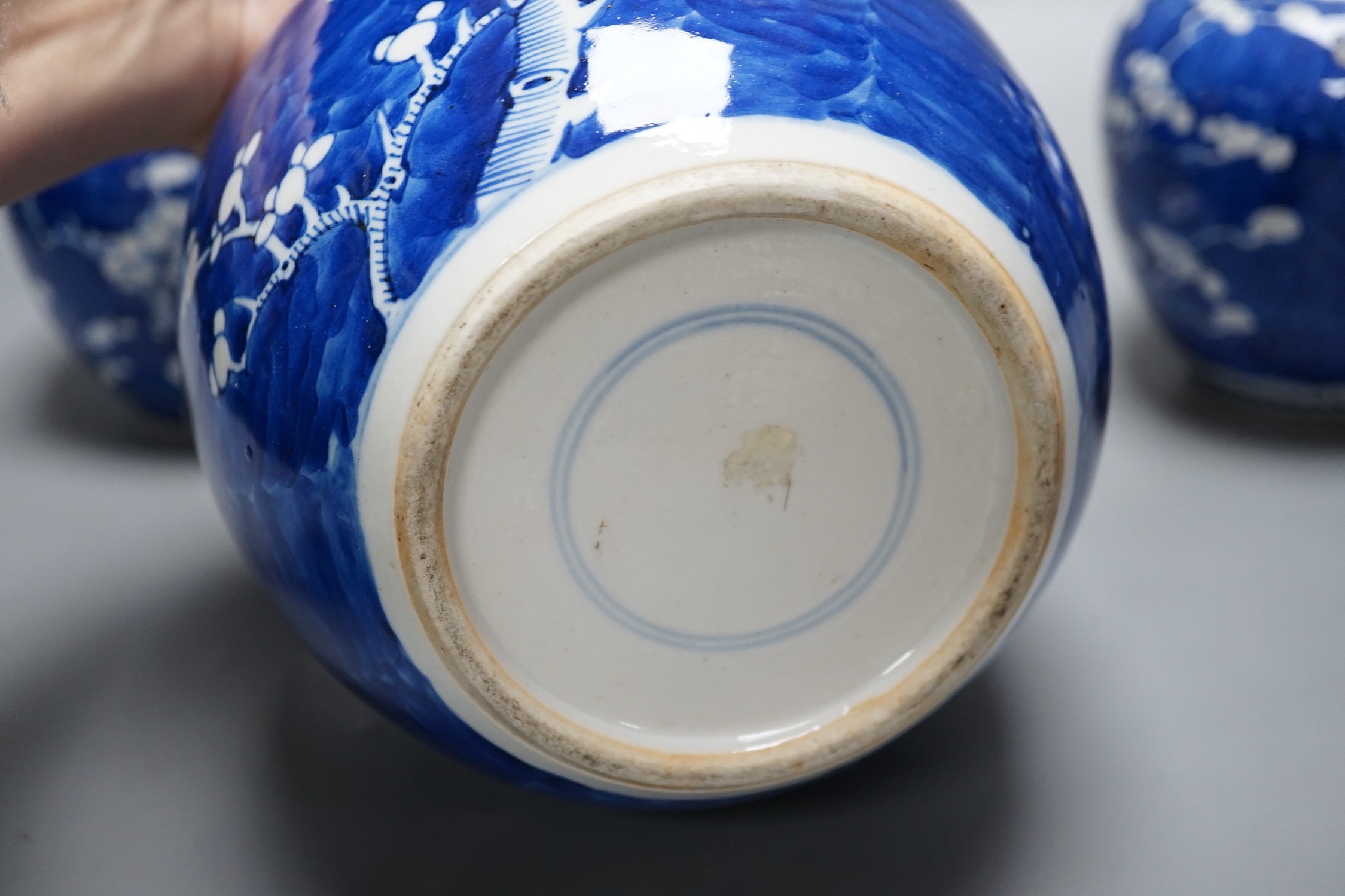 Three late 19th/early 20th century Chinese blue and white prunus jars, two covers. Tallest 16cm